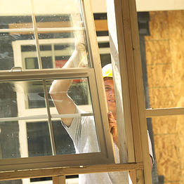 Construction worker installing a new window